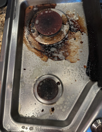 Stovetop deep cleaned by Professional Cleans LLC — before