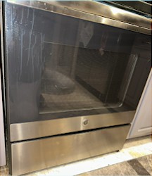 Oven door cleaned by Professional Cleans LLC — before
